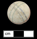 Unglazed porcelain marble decorated with intersecting sets of parallel lines in red, blue and green. This decorative motif was common from c. 1850 to 1910, although the color combination and unglazed condition of marble suggest a c. 1850s-1860s date - Click images for larger view.